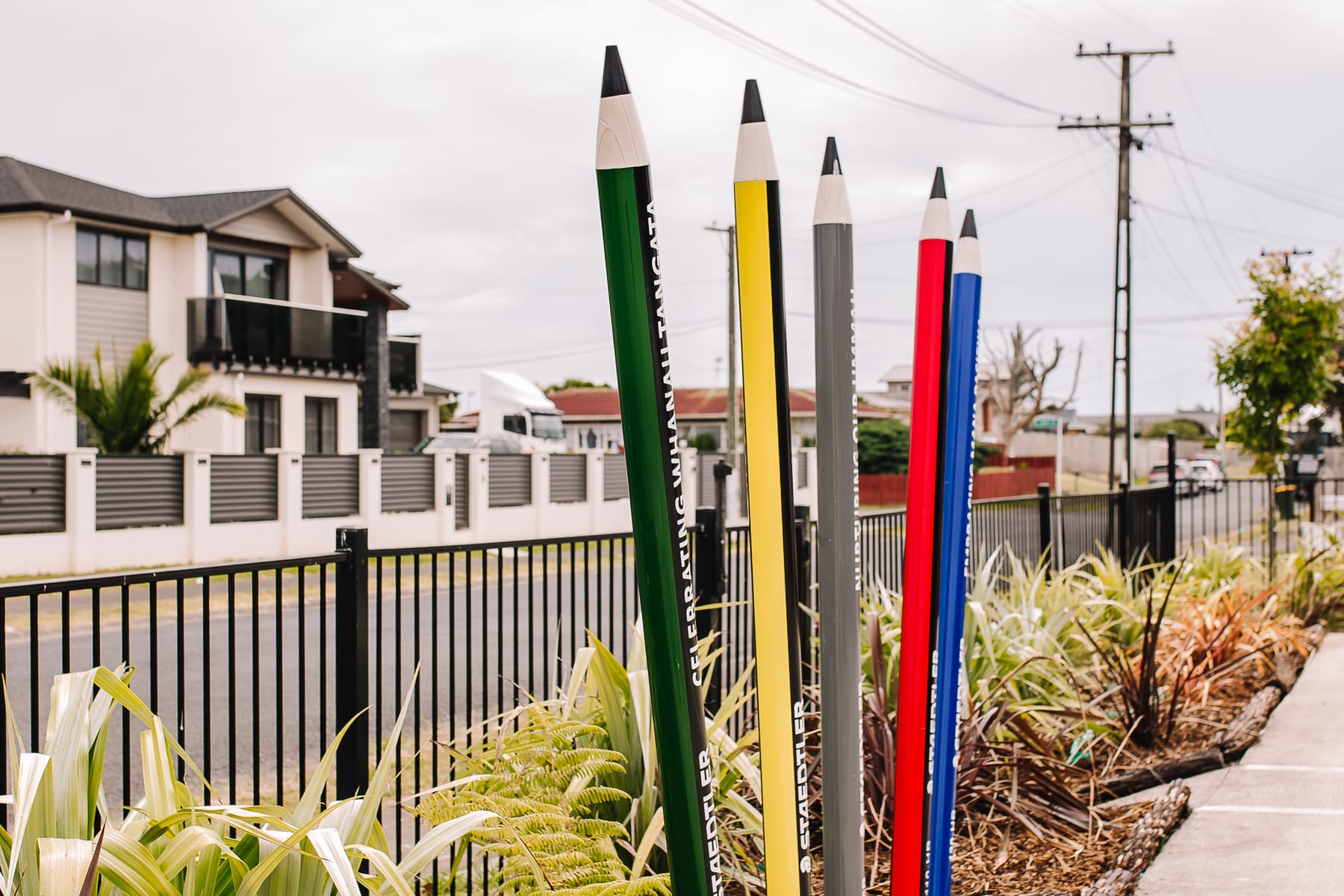 Giant coloured pencil sculptures standing at the entrance to the centre.